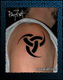Black tattoo of Nordic Horns of Odin Viking design on a person's shoulder, with 'LuckyFish.com' branding.