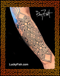 Tattoo design of Pictish spirals on a forearm with 'Lucky Fish' branding