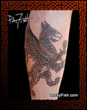 Tattoo of a rampant griffin design on a person's arm with 'Lucky Fish' branding.