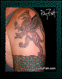Tattoo of a griffin on a person's arm above a Celtic knot band with 'Lucky Fish' branding.