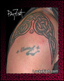 Celtic tattoo design on the top of a person's arm with intricate Celtic knot patterns and featuring the brand 'Lucky Fish'.