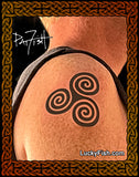 Tattoo of a triskele symbol on skin with 'Lucky Fish' branding.