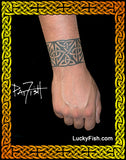 Tattoo of Celtic knotwork band on a wrist by Pat Fish and 'Lucky Fish' branding.