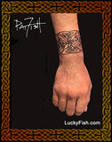 Hand with a Celtic knot band tattoo by Pat Fish, featuring the brand 'LuckyFish'.