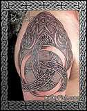 Celtic knot tattoo on a person's arm with intricate patterns.