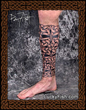 Tattoo design covering a ower leg with a decorative leg sleeve and 'Lucky Fish' branding.