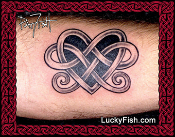 Tattoo of a Celtic heart design on skin with LuckyFish.com branding.