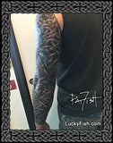 Person with a detailed tattoo on their arm made of Celtic knots by Pat Fish with 'Lucky Fish' branding.