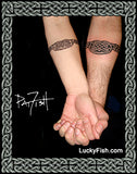 matching tattoos of welsh heart on couple forearms