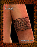 Celtic knot tattoo on a person's arm with 'Lucky Fish' branding.