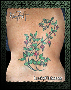 Tattoo of a fuchsia design on back with 'Lucky Fish' branding.