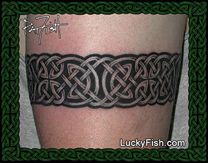Celtic knot tattoo on a person's arm with Lucky Fish.com branding.