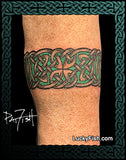 Celtic knot tattoo arm band on a person's arm with 'Lucky Fish' branding.