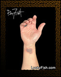 tiny Newgrange spiral on wrist