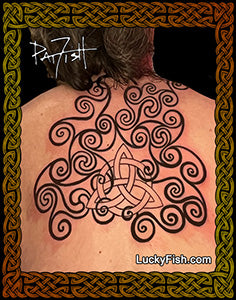 A photo of a person's back showing a spiral tattoo design, with intricate Pictish spiral patterns.