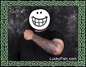 Person with Celtic knotwork sleeve tattoos on arm and LuckyFish.com branding.
