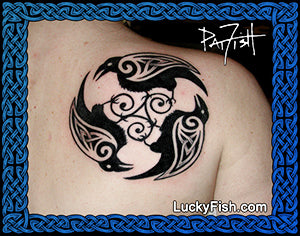 Tattoo of a Celtic triple raven design on skin with 'Lucky Fish' branding.