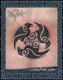 Tattoo design of three Celtic ravens intertwined with a triskele symbol on skin, branded 'Lucky Fish'.