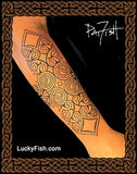 Tattoo design on a forearm with intricate Pictish spiral patterns and featuring LuckyFish.com branding.