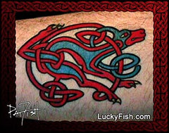 Tattoo design of a red and blue racing dog with Celtic knot patterns on forearm skin.