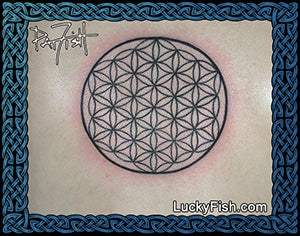 Tattoo of a flower of life symbol with Lucky Fish branding on a woman's back