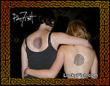 Two people with matching tattoos of the flower of life by Pat Fish on their backs with LuckyFish branding