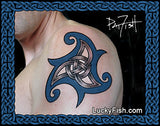 Tattoo of a Celtic knot design on a person's shoulder, featuring blue and silver-gray swirls. The image has a decorative blue border, a signature of Pat Fish in the top right, and a website watermark LuckyFish.com at the bottom.