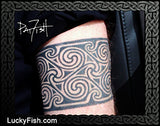 Tattoo of a Pictih spiral design on a person's arm with 'LuckyFish.com' branding.