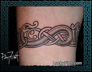 Tattoo of a snake or dragon design with Celtic knot Nordic Norse on skin, artist 'Lucky Fish' branding