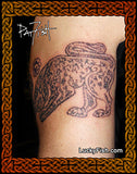 Tattoo of a Pictish animal design on skin with 'Lucky Fish' branding.