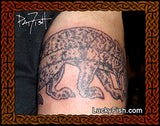 Tattoo of a Pictish animal design on a person's arm with 'Lucky Fish' branding.