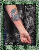 Tattoo of a Scottish horse design on a person's arm with 'Lucky Fish' branding.