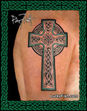 A large black and green Celtic cross tattoo design shown on a person's upper arm, with a decorative green border and the text LuckyFish.com at the bottom.