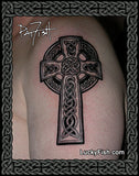 A black ink Celtic cross tattoo design shown on skin, with a decorative dark border and the brand LuckyFish.com at the bottom.