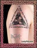 A close-up of a person's upper arm with a black Celtic triquetra knot tattoo featuring the words 'A lego mentis qua' and 'Spirit transit gloria mundi'. The image has a decorative pink and brown Celtic border frame, and a 'Lucky Fish' watermark is visible at the bottom right.