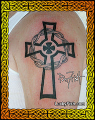 Celtic cross tattoo on a person's arm with 'Lucky Fish' branding.