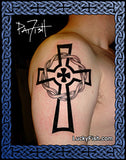 Black Celtic cross tattoo on a person's shoulder with 'Lucky Fish.com' branding.