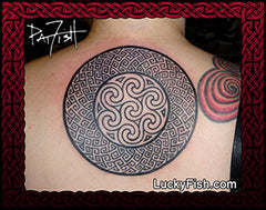 Tattoo of a Celtic Pictish key pattern knot design on a woman's back with Lucky Fish branding.