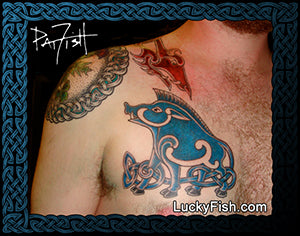 Tattoo of a blue and black Pictish boar design on a person's chest with 'Lucky Fish' branding.