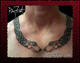 Necklace torc tattoo with intricate celtic dog design on a person's neck, featuring the brand 'Lucky Fish'.