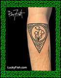 Tattoo of a triangular Celtic design with lily of the valley flowers on a person's arm, with 'LuckyFish.com' branding.
