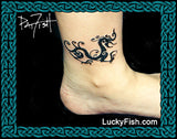 Tattoo of a black dragon design on a person's ankle with 'Lucky Fish' branding.