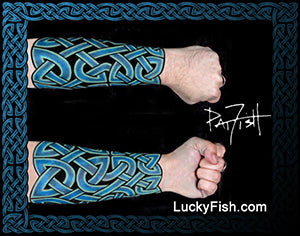 Celtic knot tattoo design on a forearm with  'LuckyFish.com' branding.