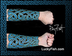 Celtic knot tattoo sleeve design on a forearm with  'LuckyFish.com' branding.