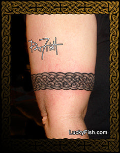 Celtic knot armband Tattoo on a person's arm with 'Lucky Fish' branding.