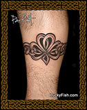 Tattoo of a Celtic knot shamrock design on a person's leg with 'Lucky Fish' branding.