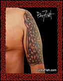 Person with a detailed arm tattoo, of Celtic knotwork and LuckyFish.com branding.