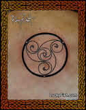 Tattoo design of a triskele symbol on skin circular Loughan Island Disc