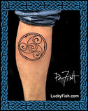 Triskele tattoo circular spirals on a person's leg with 'Lucky Fish' branding.