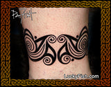 Tattoo design on a person's arm with intricate patterns, with LuckyFish.com branding